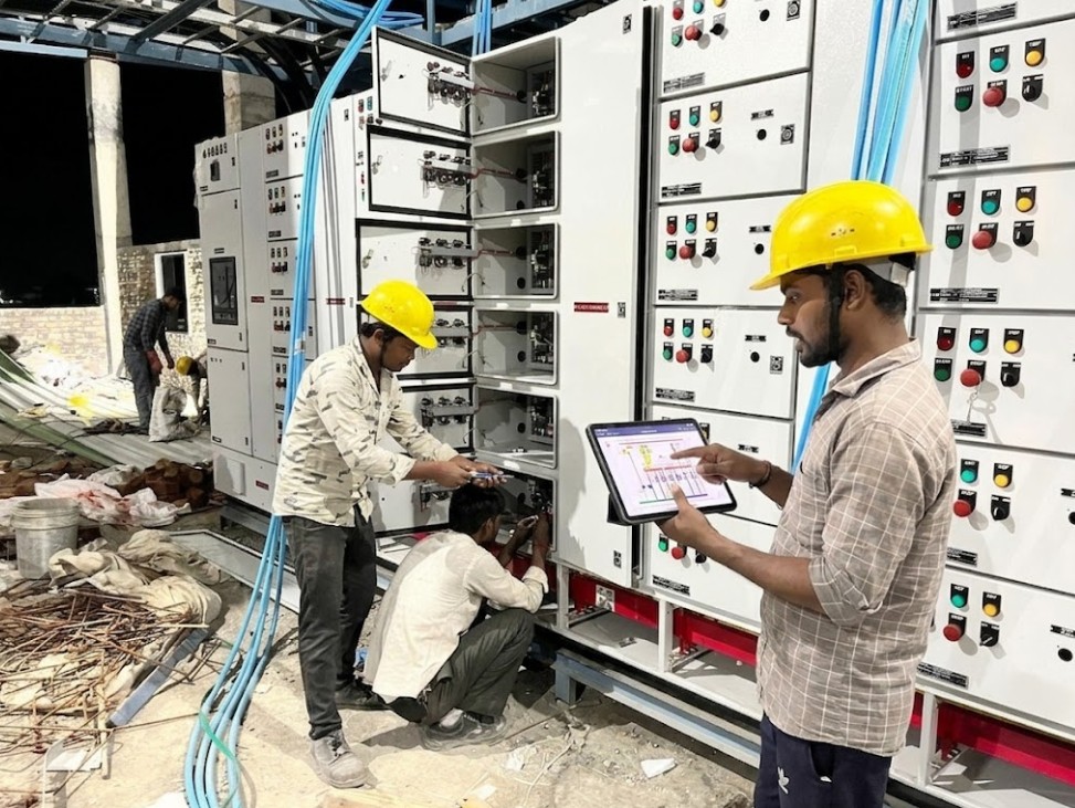 Electrical technicians commissioning industrial control panels