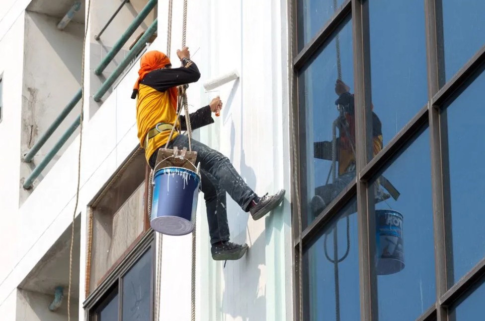 Painters applying finish coats on an interior wall